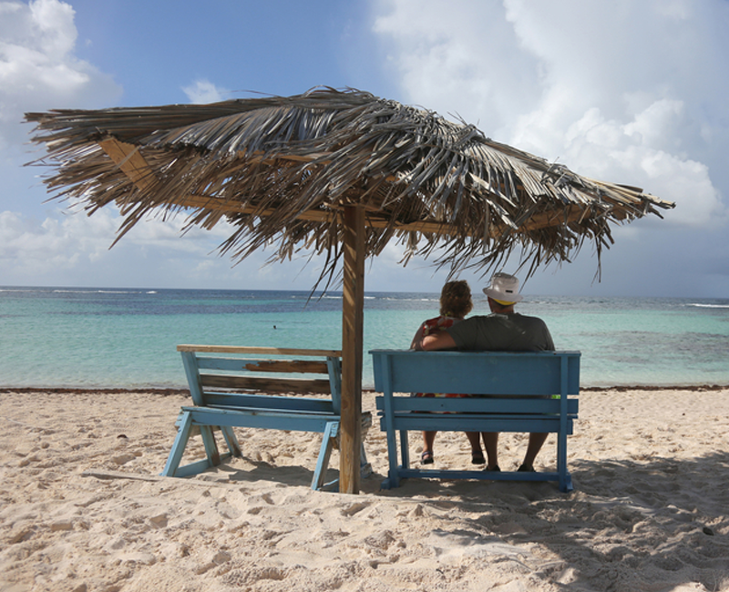 Holidays to North Africa Couple on a Beach in the Shade